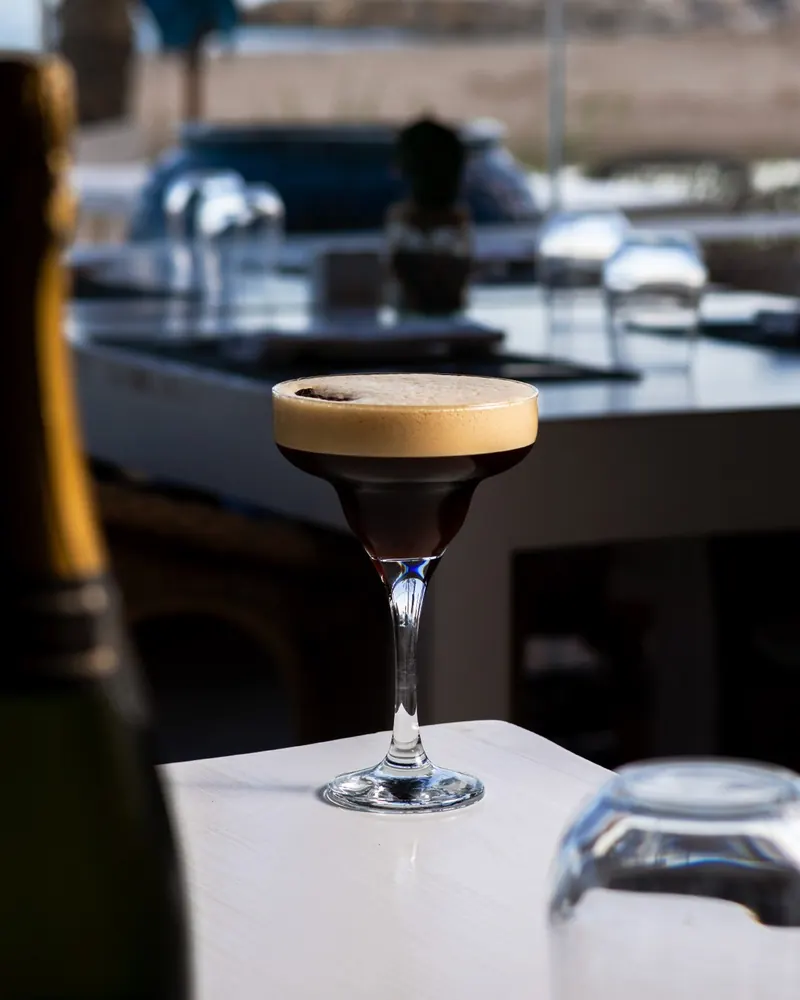 An espresso martini on a white table