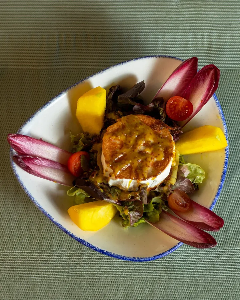 Goat cheese salad with endive, mango and cherry tomatoes, from above