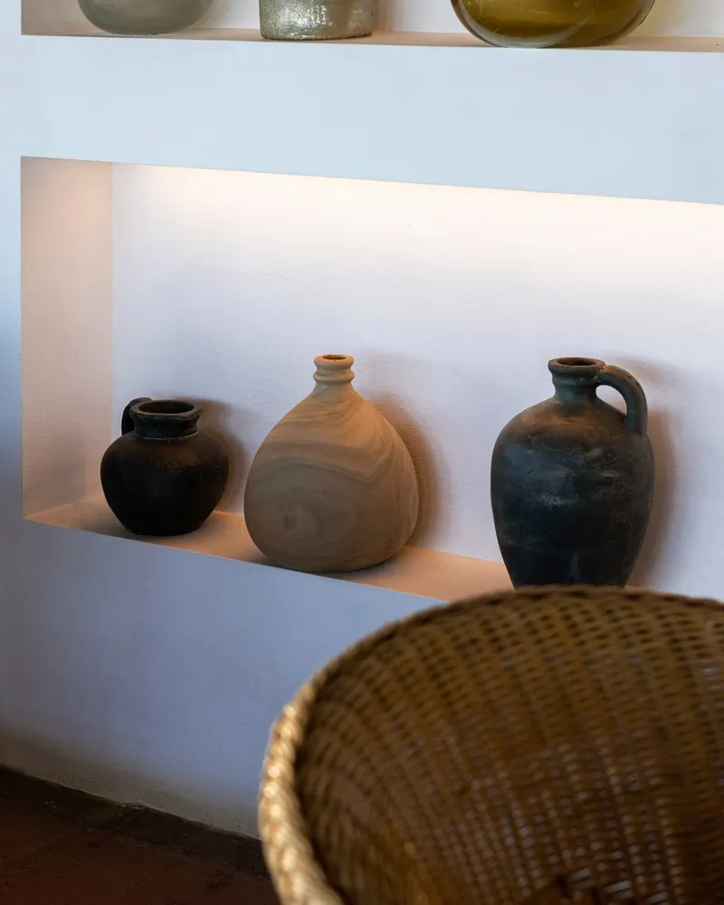 Clay pots in a lit niche