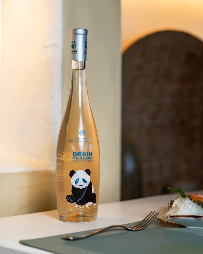 A bottle of Grain de Glace rosé on a table