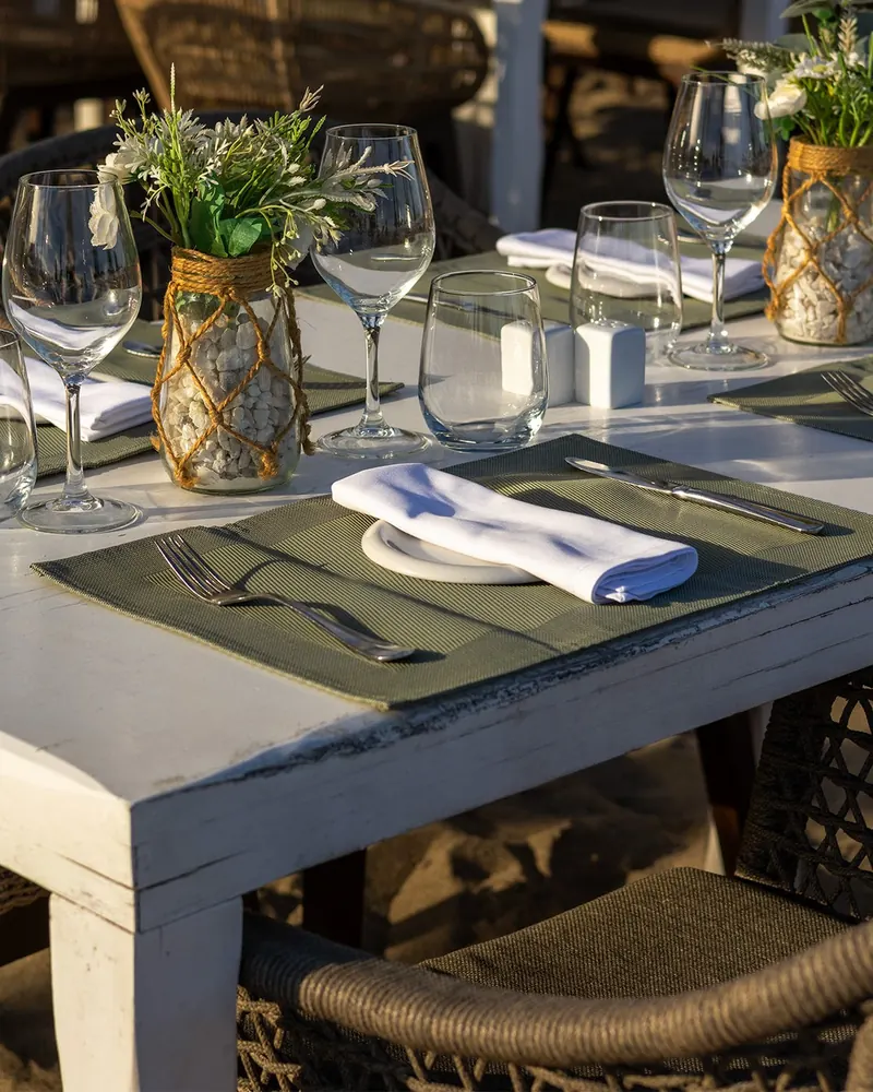 A table set with flowers and glassware